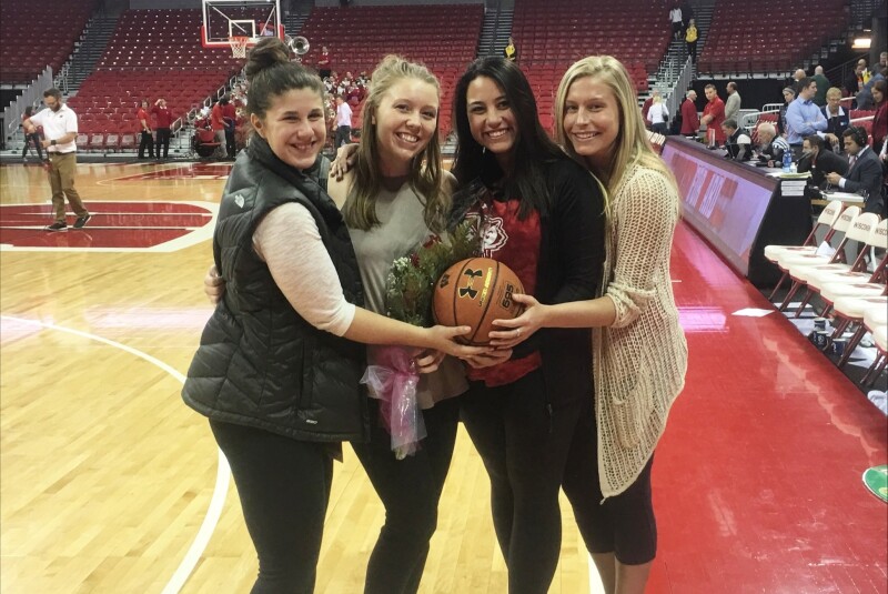 Katie Nord with Basketball Roommates on Senior Night.png