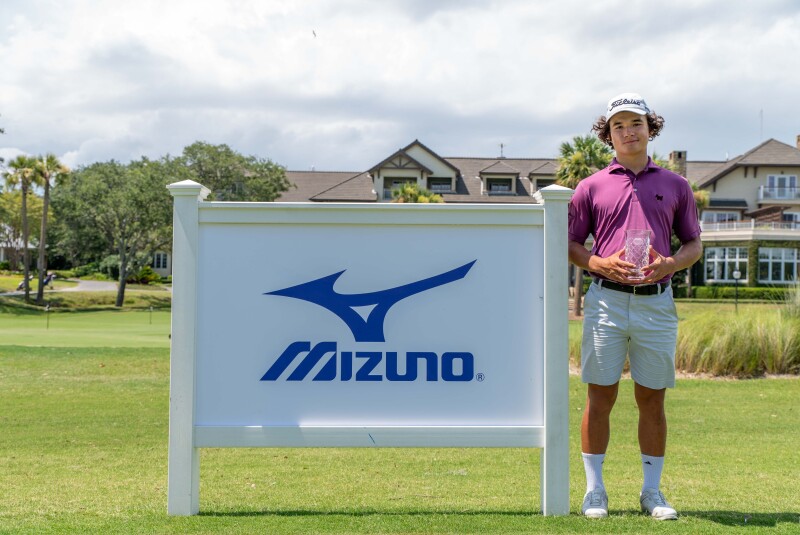 Eric Yun with trophy in front of Mizuno Banner - 2023 - Mizuno - Keith Junior Championship.jpg