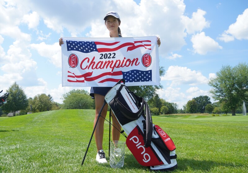 Alissa Xu with champ flag, bag, and trophy-2022-Randy Wise Junior Open.png
